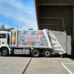a garbage truck parked in front of a building